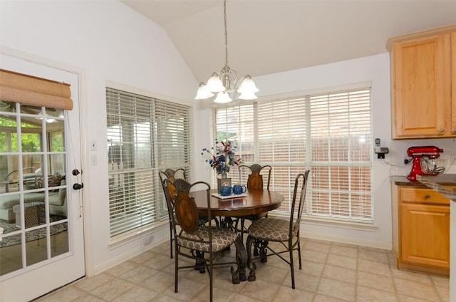 dining area featuring lofted ceiling and a notable chandelier