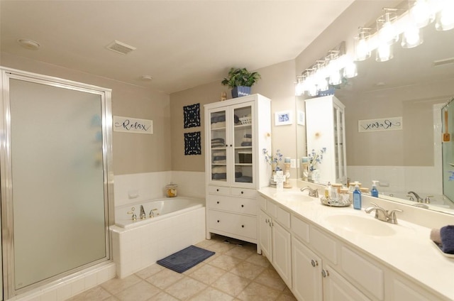 bathroom featuring vanity, tile patterned flooring, and separate shower and tub