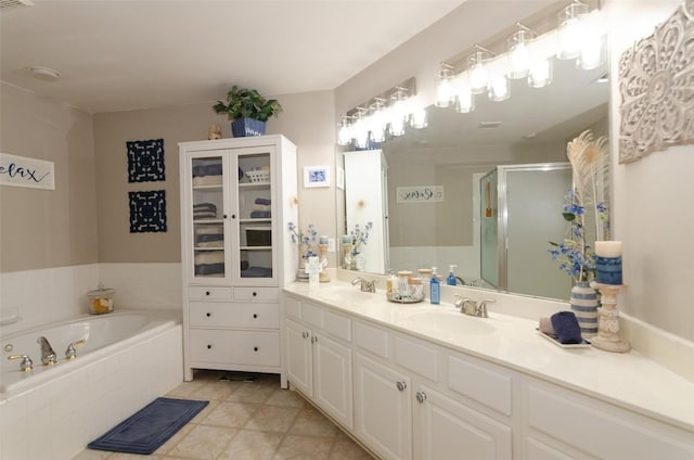 bathroom featuring tile patterned flooring, vanity, and plus walk in shower