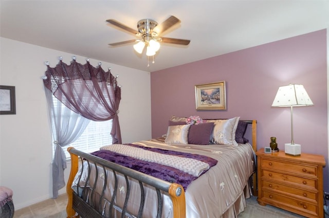 bedroom featuring light colored carpet and ceiling fan