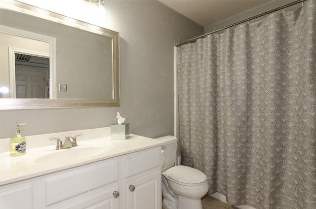 bathroom with vanity, a shower with shower curtain, and toilet