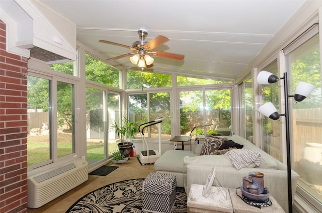 sunroom with lofted ceiling, an AC wall unit, and ceiling fan