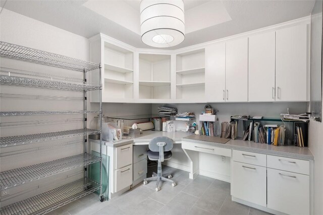 office space with light tile patterned floors and built in desk