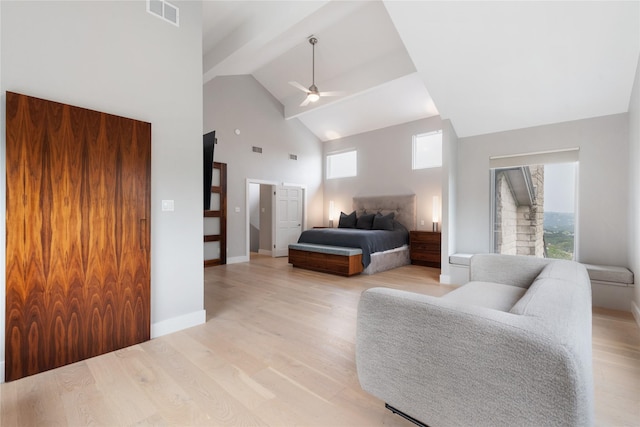 bedroom with a high ceiling, ceiling fan, and light hardwood / wood-style flooring