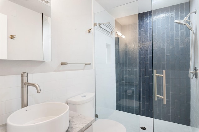 bathroom with vanity, tile walls, an enclosed shower, and toilet