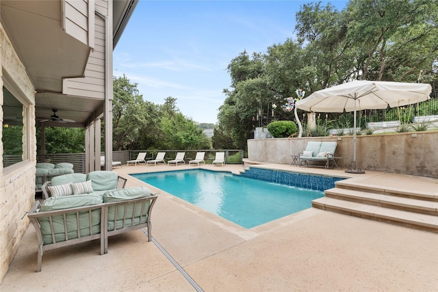 view of pool with an outdoor hangout area, a patio area, pool water feature, and ceiling fan