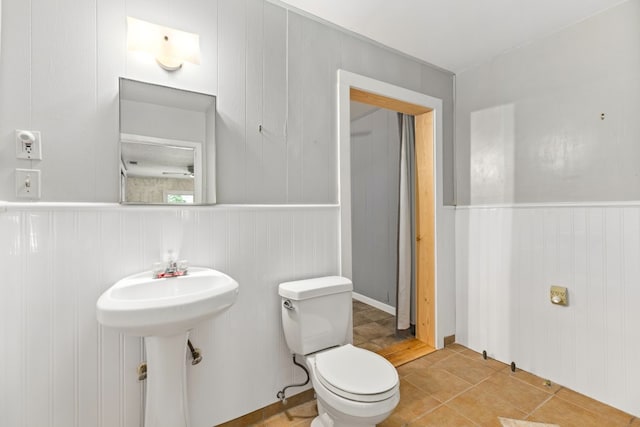 bathroom featuring tile patterned floors, toilet, and sink