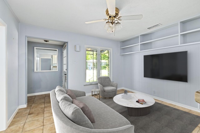 tiled living room featuring ceiling fan