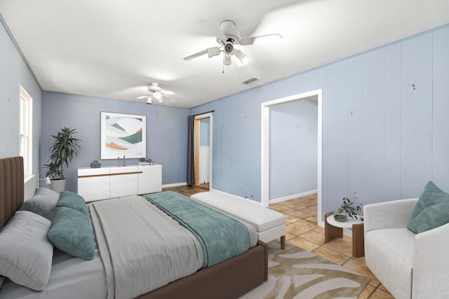 bedroom featuring light tile patterned floors and ceiling fan