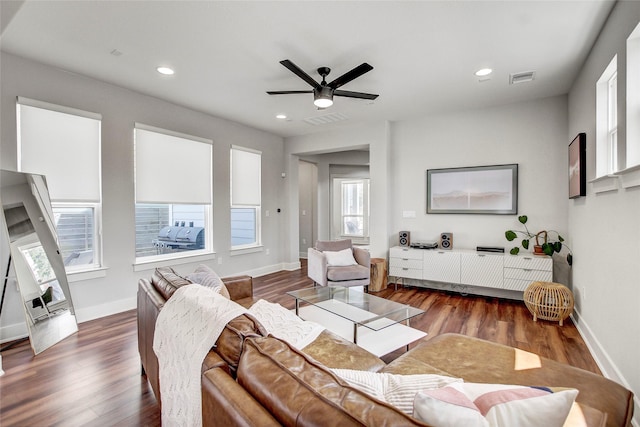 living room featuring ceiling fan and dark wood-type flooring