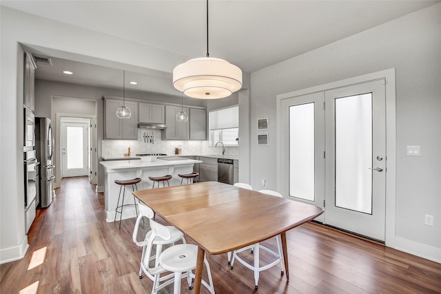 dining area with sink and hardwood / wood-style flooring