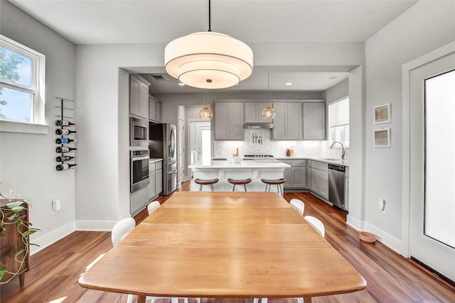 dining room with dark hardwood / wood-style flooring and sink