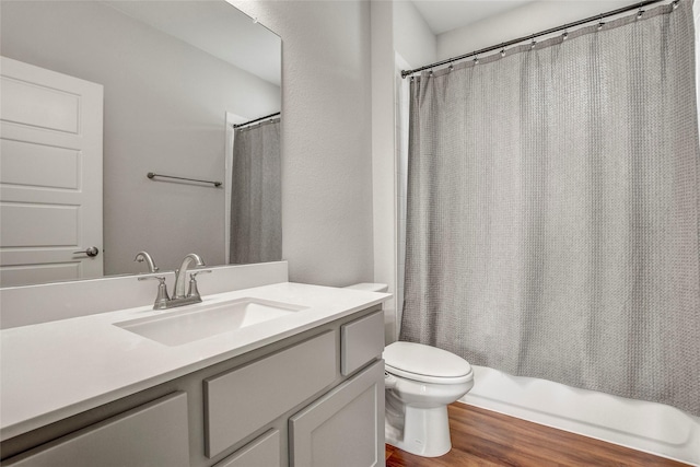 full bathroom featuring toilet, shower / tub combo, vanity, and hardwood / wood-style flooring