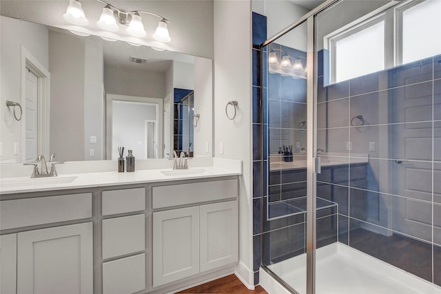 bathroom with an enclosed shower and vanity