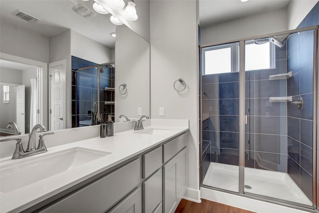 bathroom featuring vanity, a shower with shower door, and hardwood / wood-style flooring