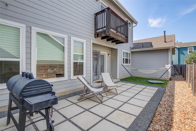 view of patio featuring a balcony and area for grilling