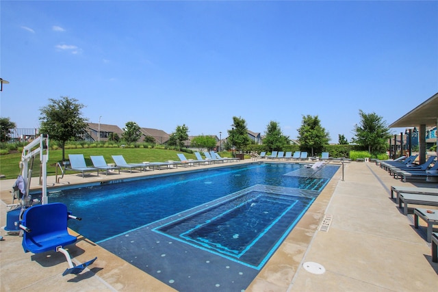 view of swimming pool featuring a yard and a patio