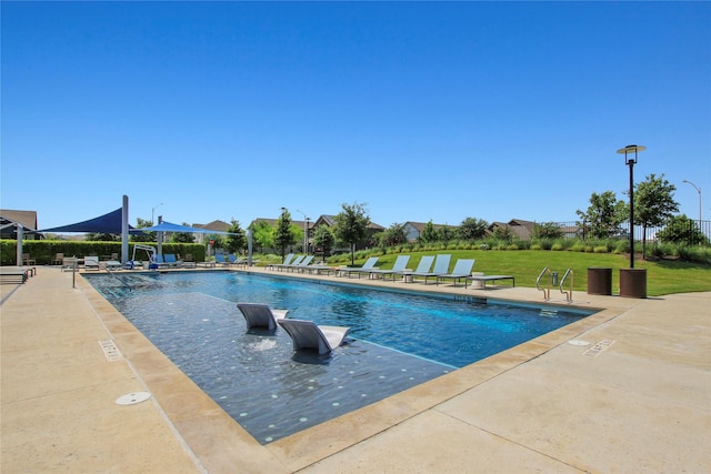 view of pool featuring a lawn and a patio area