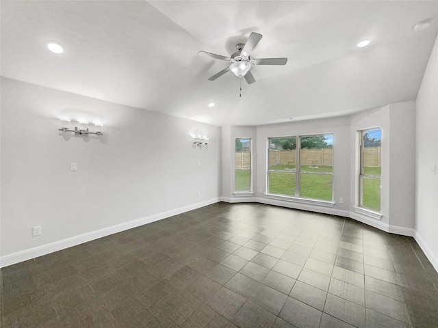 unfurnished room featuring dark tile patterned flooring, ceiling fan, and lofted ceiling