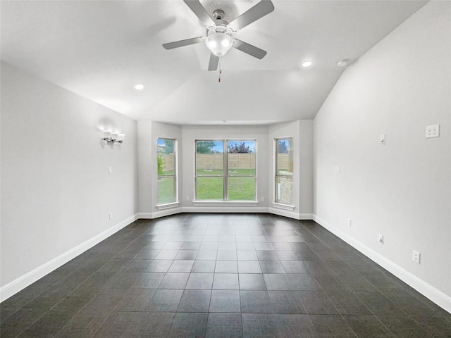 empty room with ceiling fan and vaulted ceiling