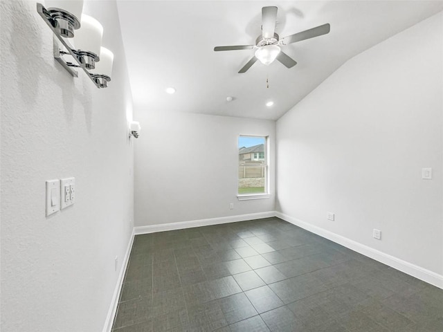 unfurnished room featuring dark tile patterned flooring, ceiling fan, and lofted ceiling