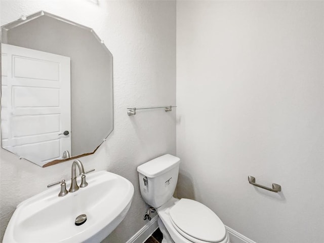 bathroom featuring toilet and sink