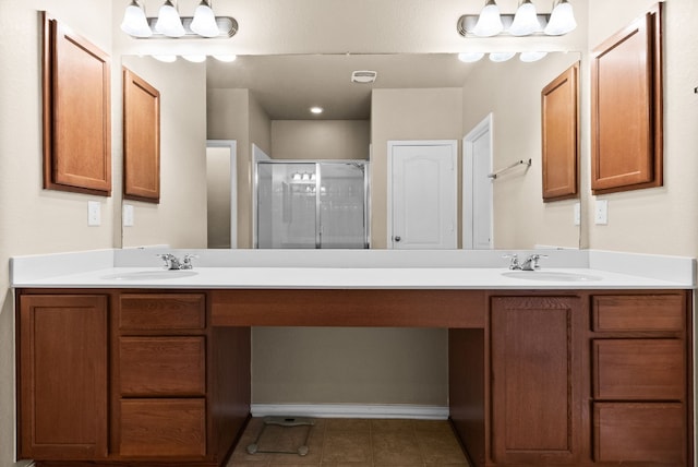 bathroom featuring tile patterned flooring, vanity, a chandelier, and a shower with shower door