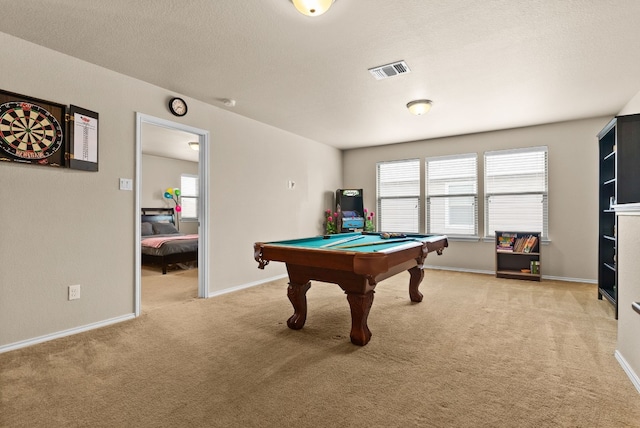 recreation room featuring light colored carpet, a textured ceiling, and pool table