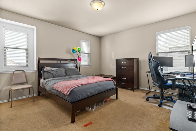 carpeted bedroom featuring multiple windows