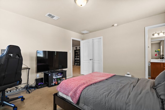 bedroom with carpet flooring and connected bathroom