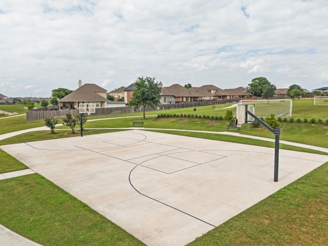 view of sport court with a lawn