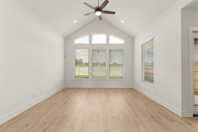 empty room with light hardwood / wood-style floors, lofted ceiling, and ceiling fan