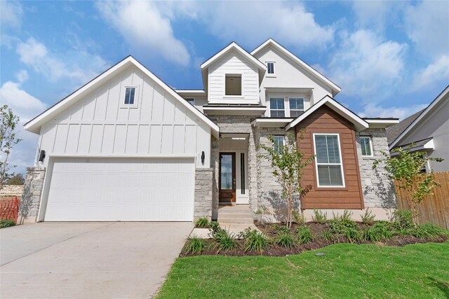 view of front facade featuring a garage and a front lawn