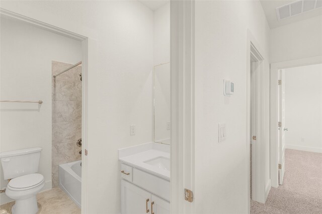 full bathroom with toilet, tiled shower / bath combo, and vanity