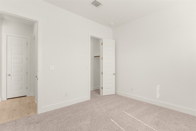 unfurnished bedroom with light carpet