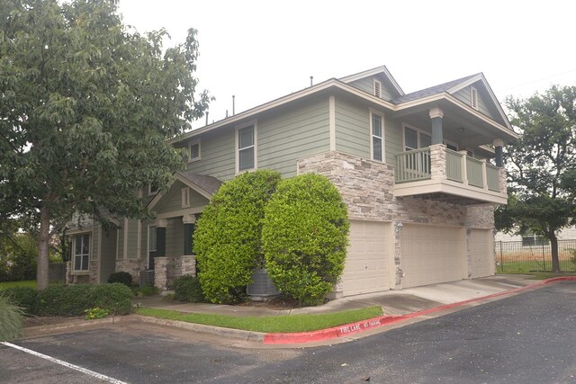 view of front facade with a balcony and a garage