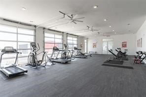 workout area with a wall of windows and ceiling fan