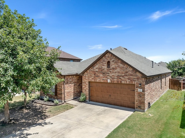 view of front of property with a garage and a front lawn