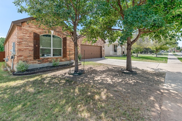 view of front of home with a front yard and a garage