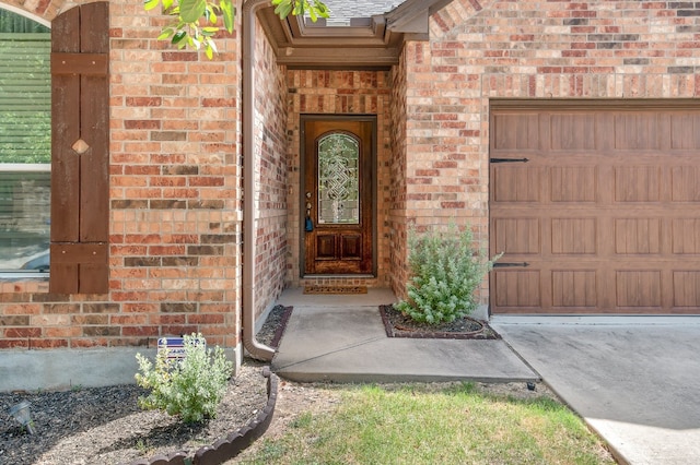 view of exterior entry with a garage