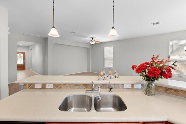 kitchen featuring a healthy amount of sunlight, sink, and hanging light fixtures