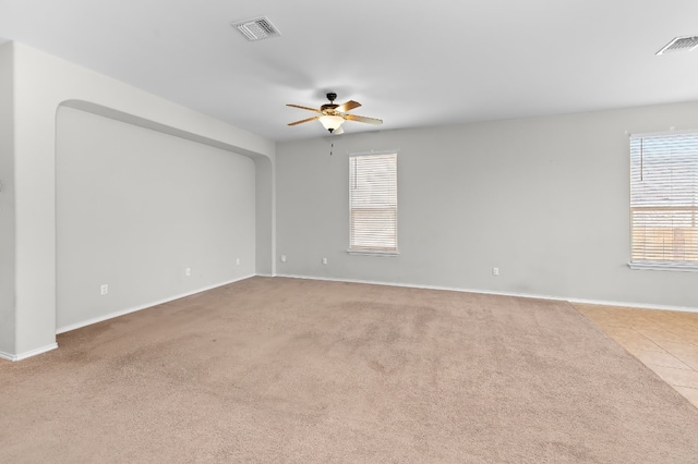 spare room featuring ceiling fan and light carpet