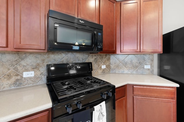 kitchen featuring black appliances and backsplash