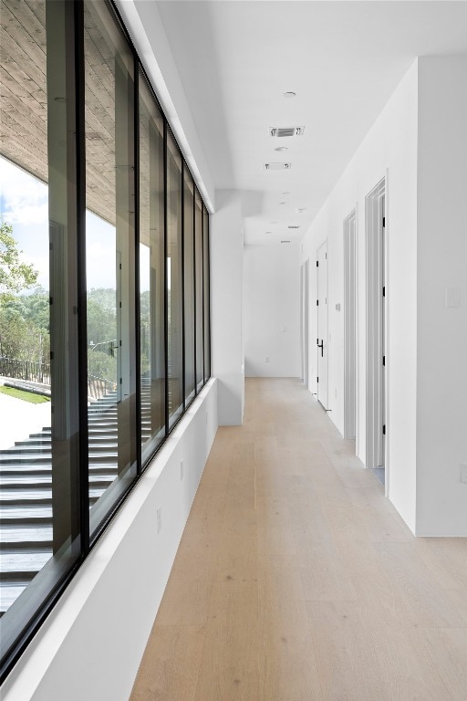 hallway with light hardwood / wood-style flooring