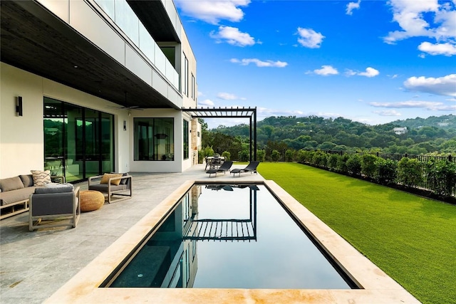 view of pool featuring a pergola, ceiling fan, a patio area, and a lawn