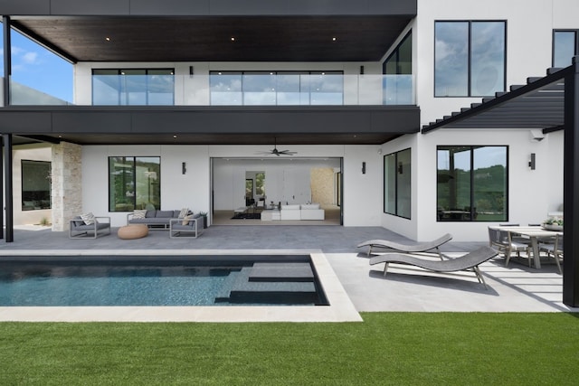 back of house with outdoor lounge area, ceiling fan, and a patio area