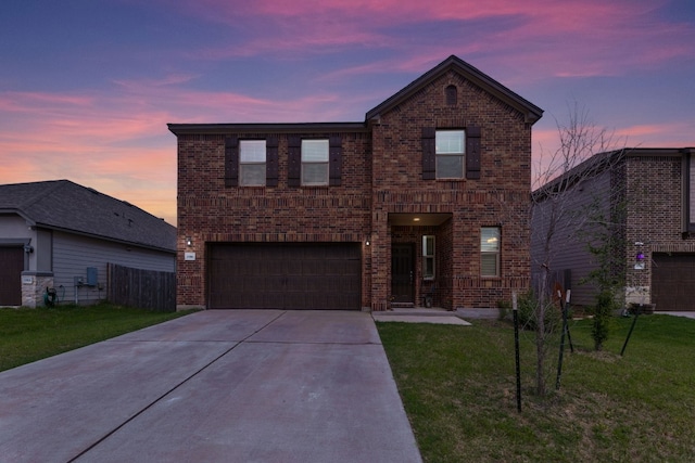 front of property featuring a garage and a yard