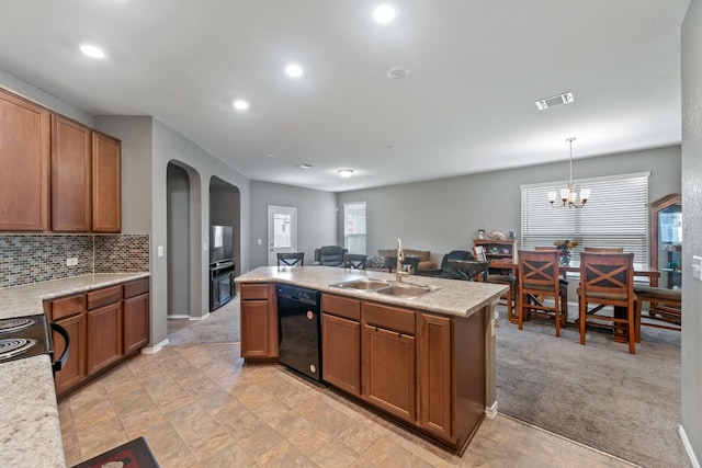 kitchen featuring light carpet, open floor plan, light countertops, black appliances, and a sink