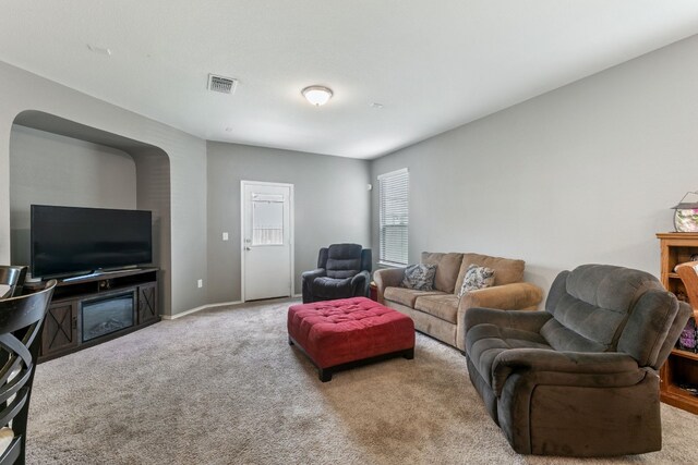 living room featuring carpet flooring, visible vents, and baseboards