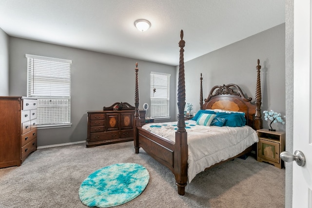 bedroom featuring multiple windows and light colored carpet